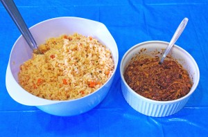 This photo shows a bowl of flavorful, golden colored rice next to another bowl of spicy Mole.