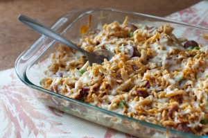 This picture shows a bubbly Smoked Sausage and Penne casserole in a glass dish.