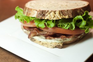 this picture is of a delicious BLT on artisan bread with pesto mayonnaise