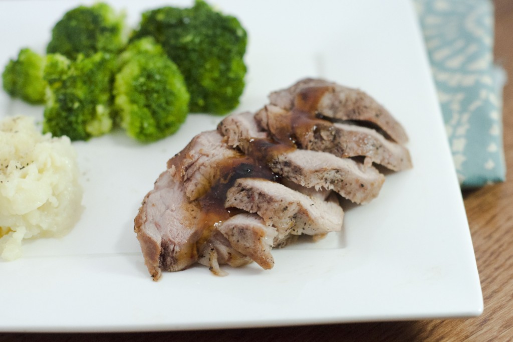 an image of brined teriyaki pork tenderloin with broccoli and potato in the background