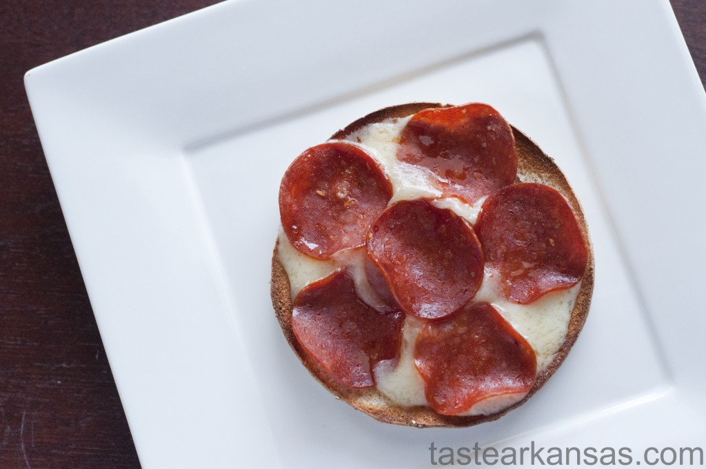 this photo is of a pizza crisp made from a sandwich thin, havarti cheese and turkey pepperoni