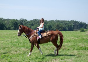 Daughter Katie Ella rides her horse which she competes in rodeos with. 