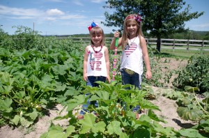 Josie and Abby working in the garden, one of their favorite activities on the farm. 